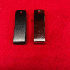 Two metal clips on red background.