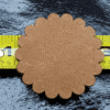 Brown scalloped circle on measuring tape.