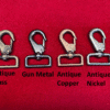 Four metal swivel clasps on red background.