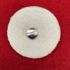 Round felt pad with metal screw center.