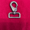 Metal hook on red fabric background.