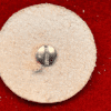 Round abrasive disc with metal screw center.