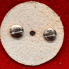 Round abrasive disc with two metal screws.