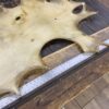 Stretched animal hide on wooden table.