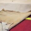 Leather hide with measuring tape on fabric.