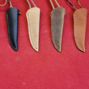 20230420_121410 Leather knife sheaths on red background.