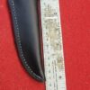 Leather knife sheath beside measuring ruler.