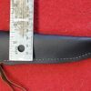 Leather knife sheath with measuring ruler on top.