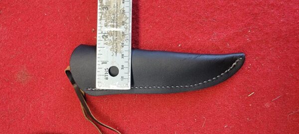 Leather knife sheath with measuring ruler on top.