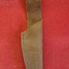 Leather knife sheath on red fabric background.