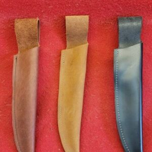 20230420_144458 Three knife sheaths on a red surface
