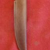 Knife sheath on red fabric background.