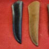 Black and brown knife sheaths on display.