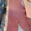 Brown leather sheets on wooden surface.