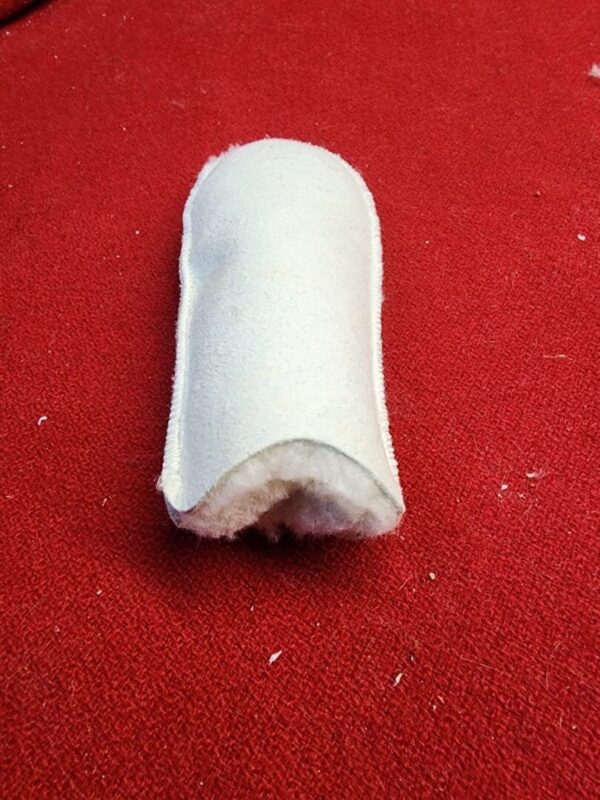 White padded object on red surface.