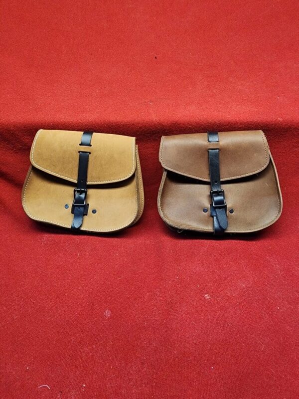 Two leather satchels on a red background.