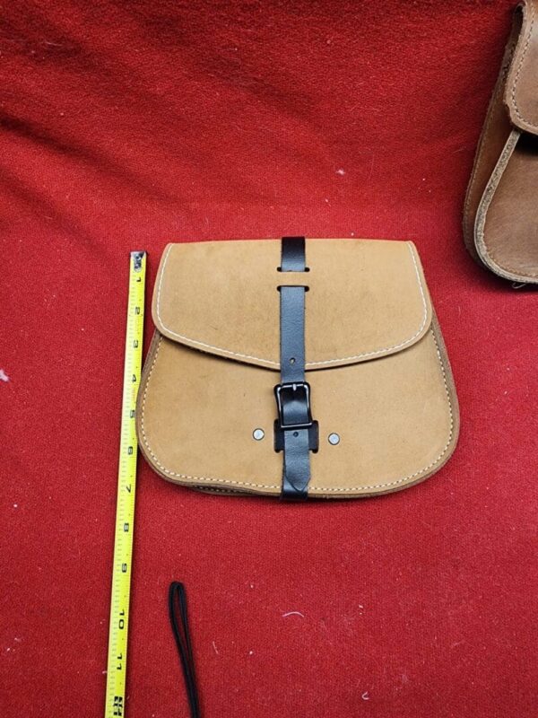 Brown leather satchel with measuring tape.