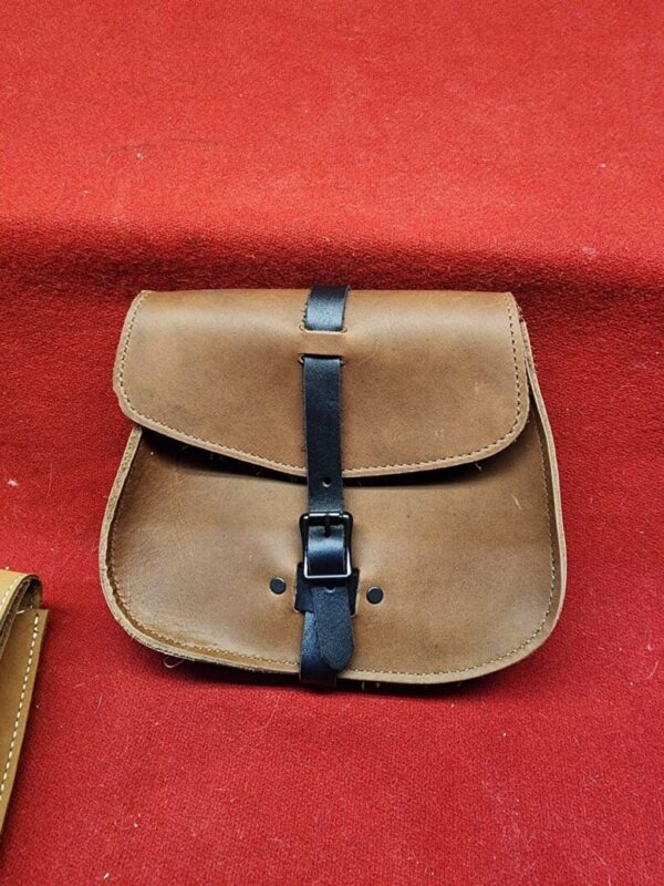 Brown leather pouch with black strap buckle.