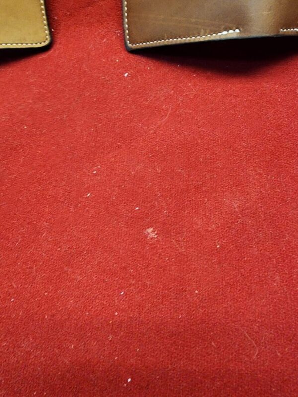 20231221_184432 Red carpet with two leather wallets visible.