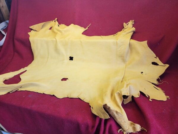 Yellow animal hide on red fabric background.