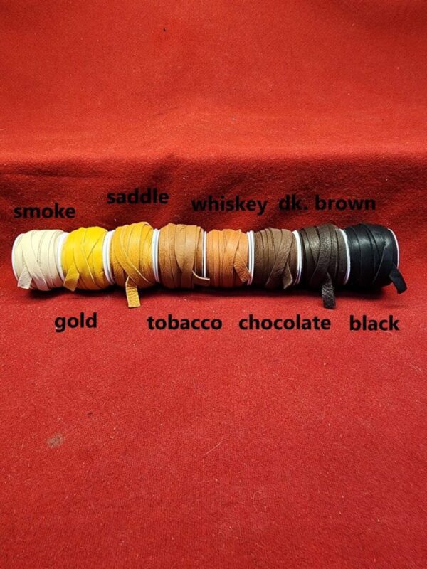 Colored leather laces on red background.