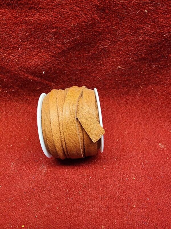 Brown leather cord on red background.