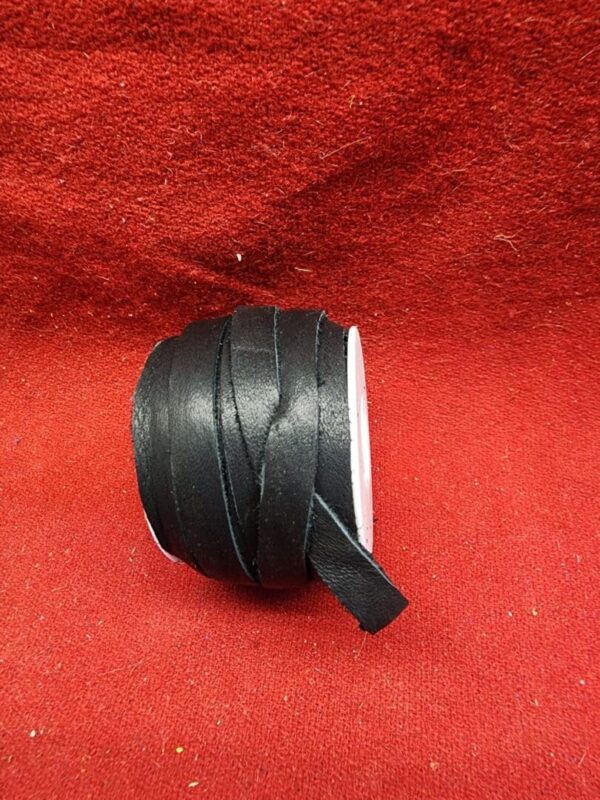 Black leather strap on red background.