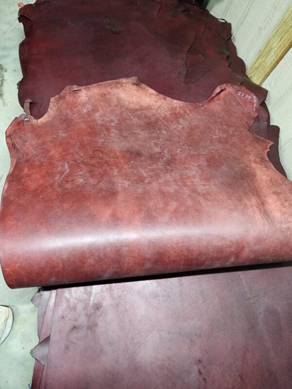 20240215_180125 Stack of brown leather hides.