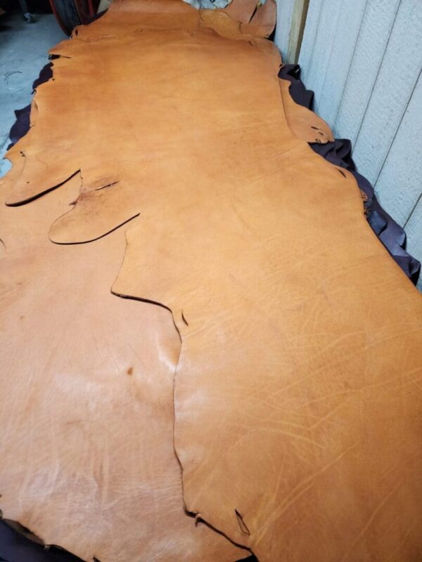 Brown leather hide on a flat surface.