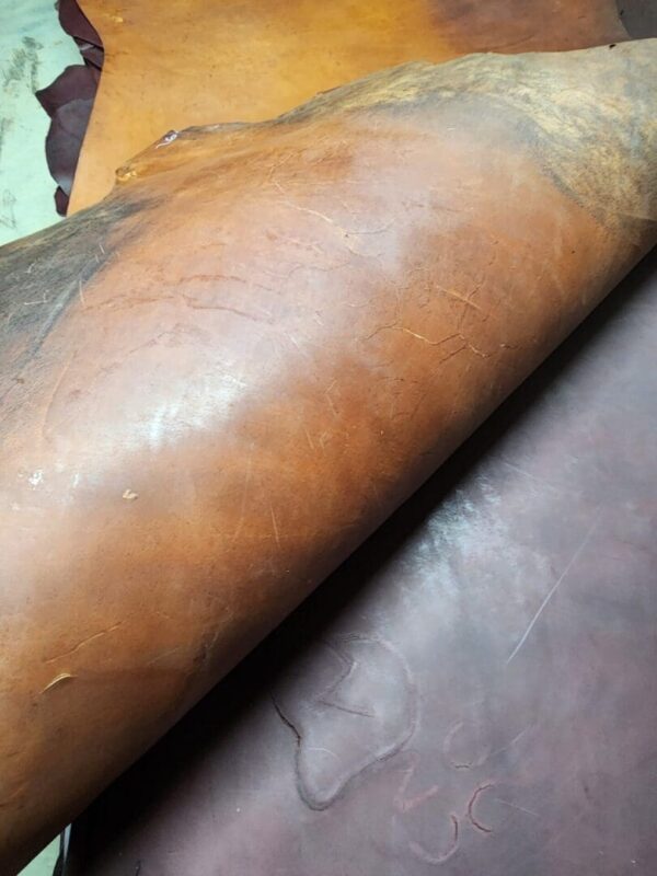 20240215_180604 Rolls of brown leather on display.