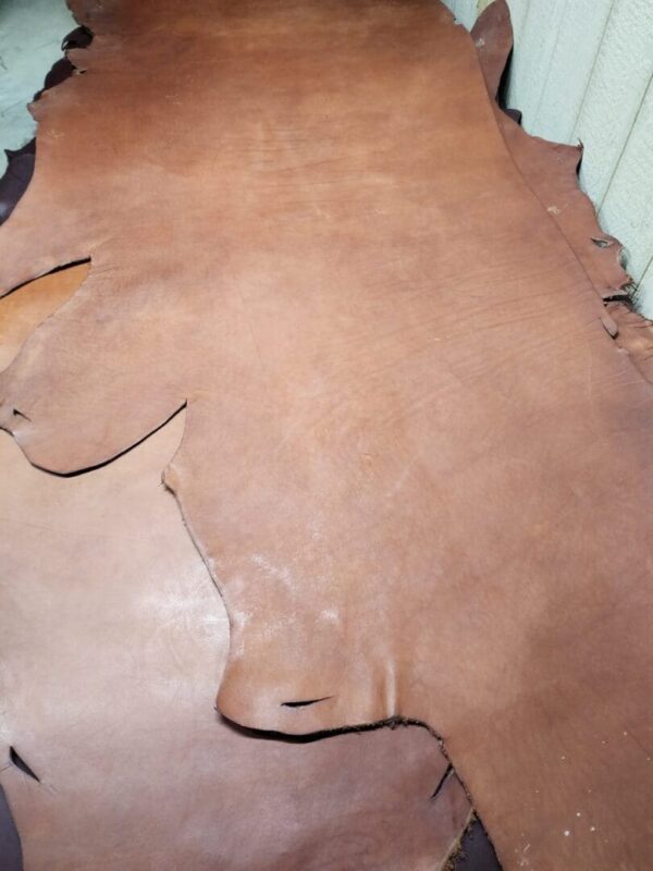 Brown leather hide on a flat surface.
