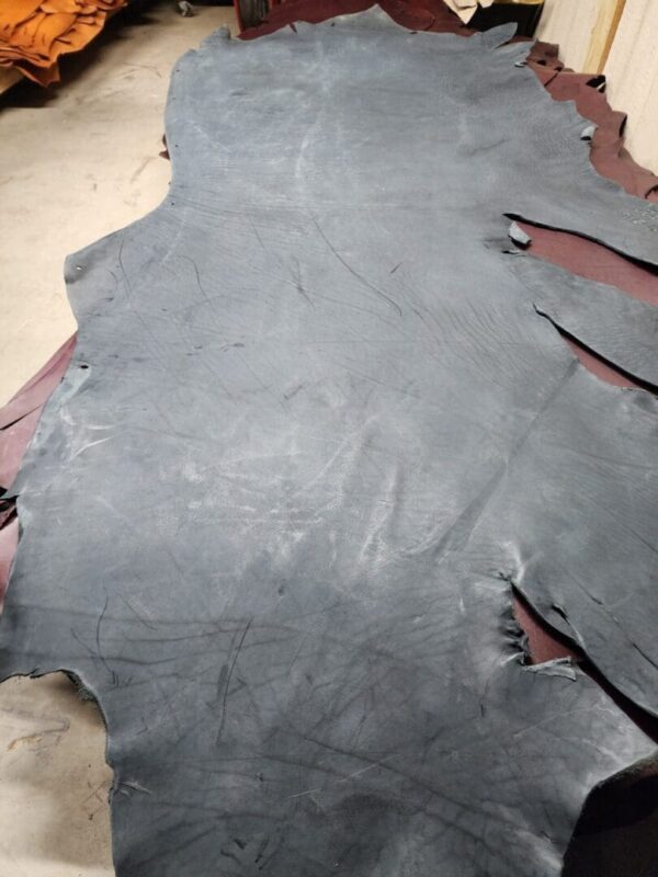 20240215_180935 Gray leather hide on a workshop table.