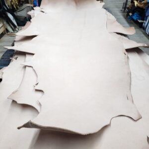 20240227_171401 Leather hides stacked in a workshop.