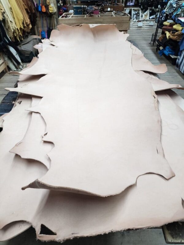 Leather hides stacked in a workshop.