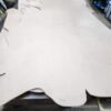Large piece of raw leather on table.