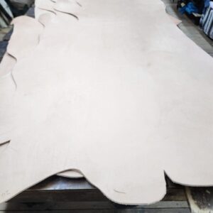 20240227_171515 Large piece of raw leather on table.