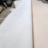 Large rolls of leather on wooden table.