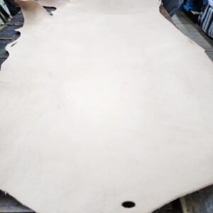 20240227_172251 Large piece of tan leather on table.