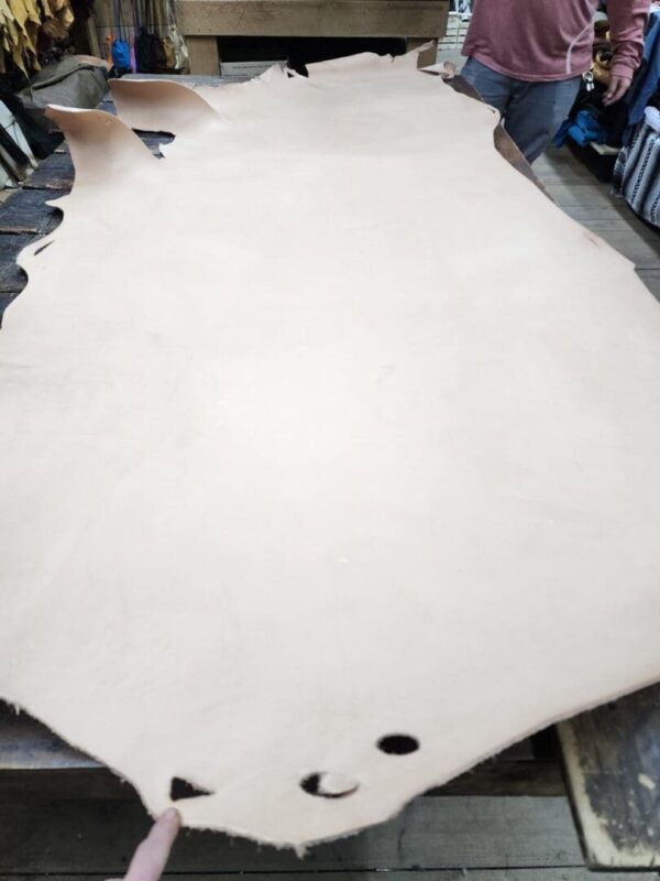 Large piece of tan leather on table.