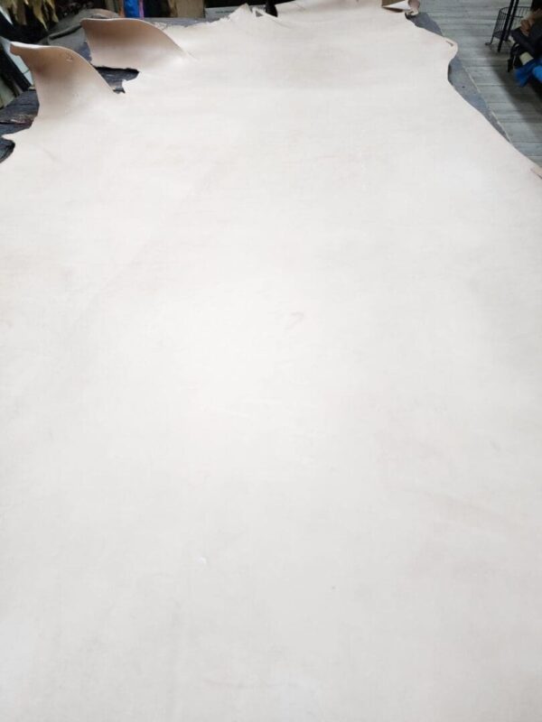 Large piece of tan leather on table.