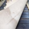 Rolled leather hide on wooden table.