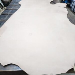 20240227_172434 Large piece of leather on wooden table.