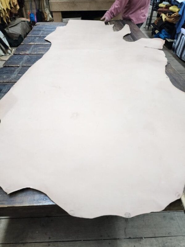 Large piece of leather on wooden table.
