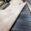 Leather roll on wooden table in workshop.