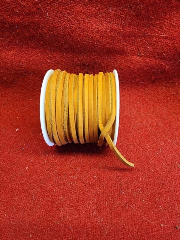 Roll of orange suede leather cord.