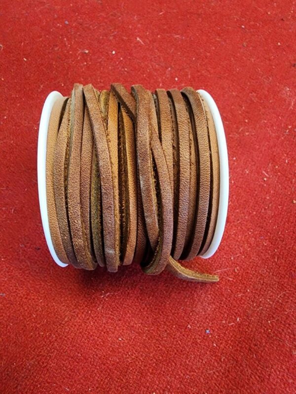 Brown leather laces on a spool.