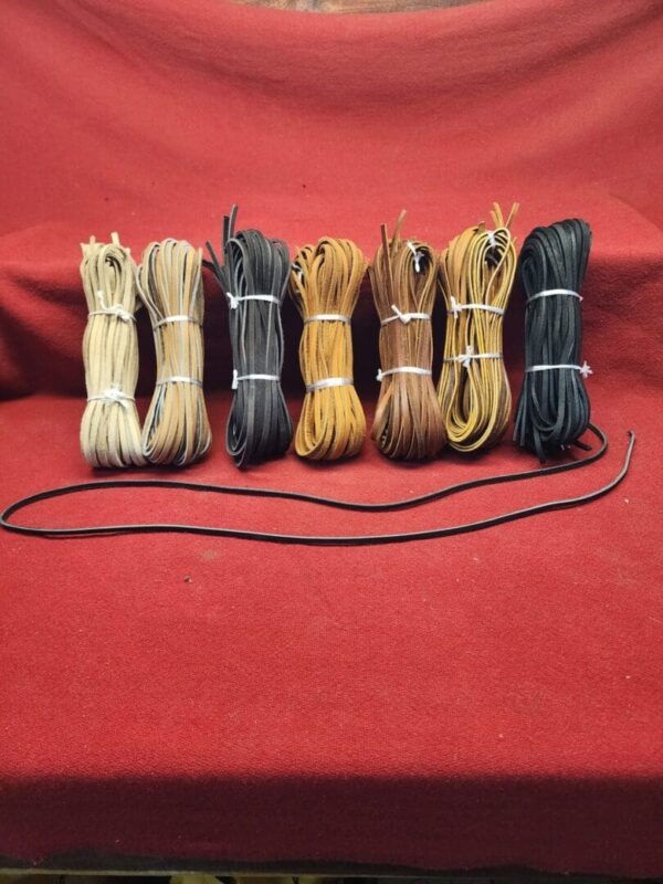 Bundles of colorful leather strings on display.