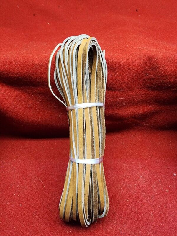 Bundle of leather strips on red fabric.