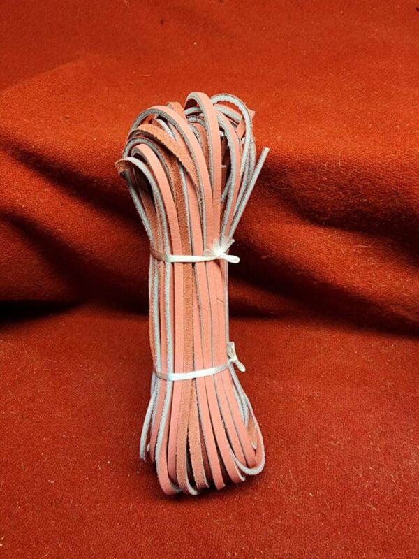 Bundle of pink leather straps on fabric.