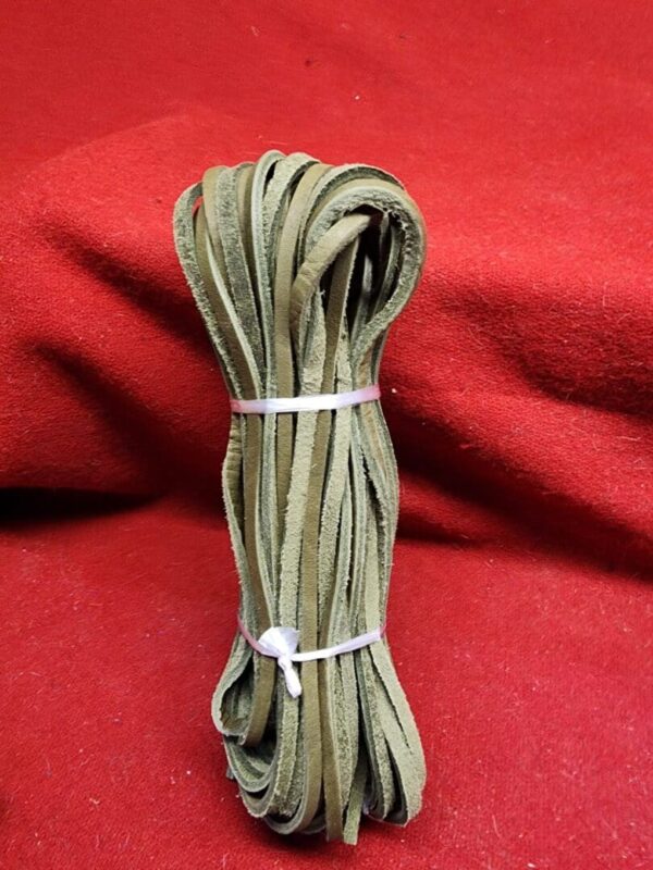 Bundle of green leather strips on red.